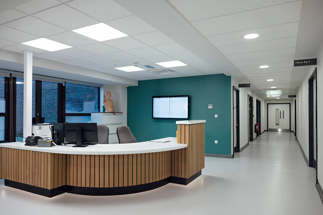 Modern healthcare reception area with teal accent wall, designed by an interior painter in Dublin, OH, to create a calming and professional space