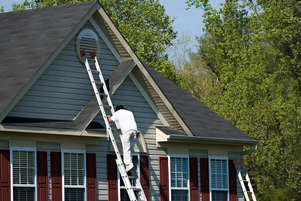 Professional exterior painter in Dublin, OH, painting trim on a residential exterior