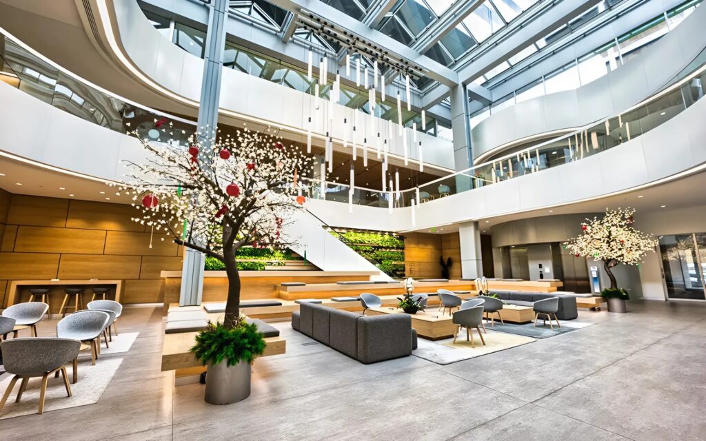 Festive lobby with modern seating and decorated holiday trees by a painting company in Dublin, OH