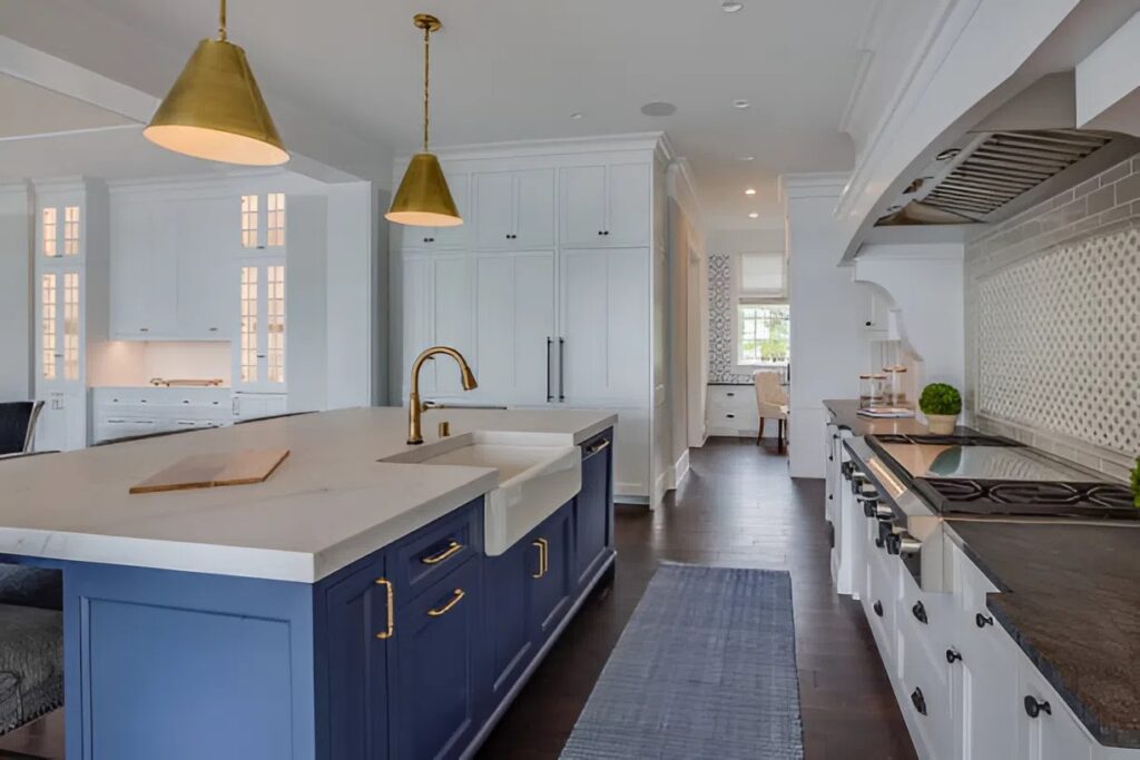 Kitchen featuring fresh white cabinet paint and a bold blue island painted by a painter in Grove City, OH