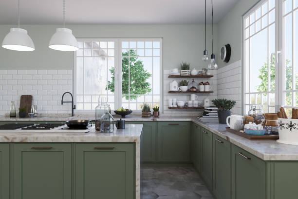 Sage green painted cabinets with white trims and countertops by a house painter in Westerville, OH.