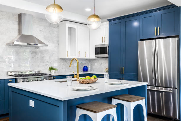 Bold navy blue and white painted cabinets with bright interior finishes by a house painter in Westerville, OH.
