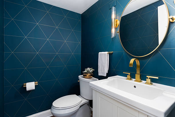 Bathroom with deep blue walls and moisture-resistant paint by a house painter in Bexley, OH.