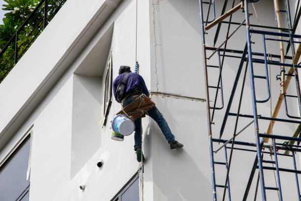 Commercial exterior painter applying fresh paint to a multi-story building, showcasing professional services from a trusted painting company in Lewis Center, OH.